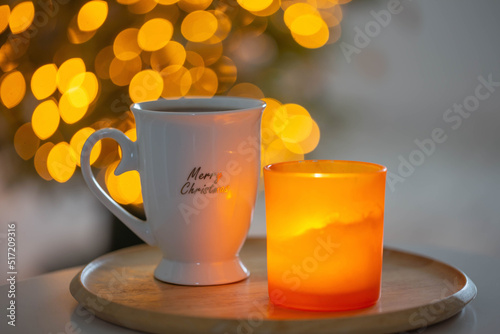 cup with hot drink on background christmas tree