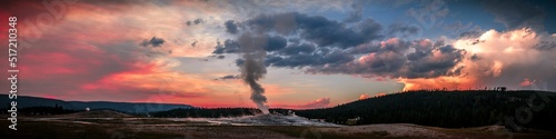 Fototapet Panoramic view of Old Faithful Geyser at colorful sunset in Yellowstone National