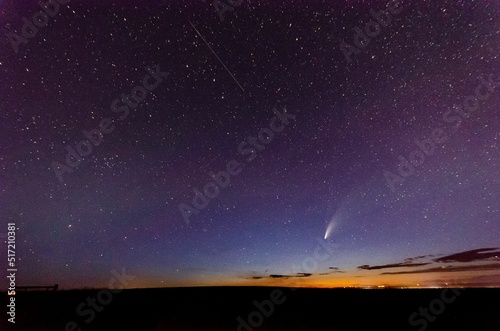 Breathtaking view of Neowise comet in blue starry sky from Great Falls, Montana photo