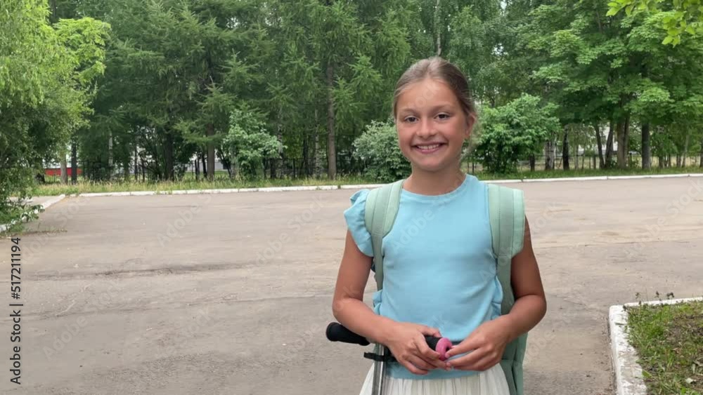 portrait of a happy girl going to school, it's time to go to school, a little girl with long dark hair smiles and looks at the camera