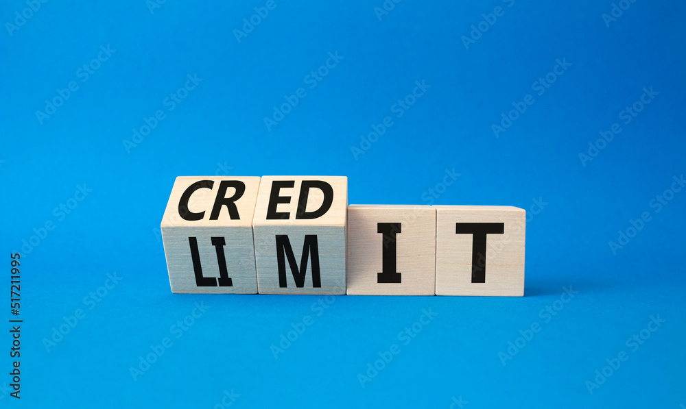 Credit limit symbol. Turned wooden cubes with words credit and limit. Beautiful blue background. Business and Credit limit concept. Copy space Credit limit symbol. Turned wooden cubes with words credit and limit. Beautiful blue background. Business and Credit limit concept. Copy space