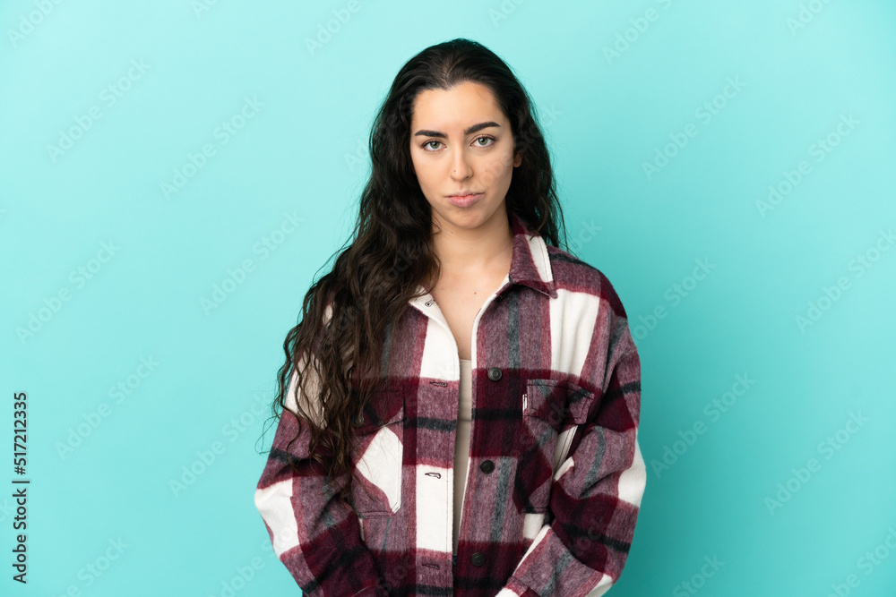 Young caucasian woman isolated on blue background with sad expression Young caucasian woman isolated on blue background with sad expression