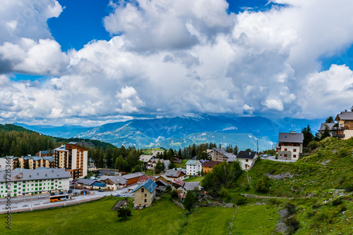 A picturesque landscape view of the French Alps mountains and the ski resort buildings on a summer day (Valberg)