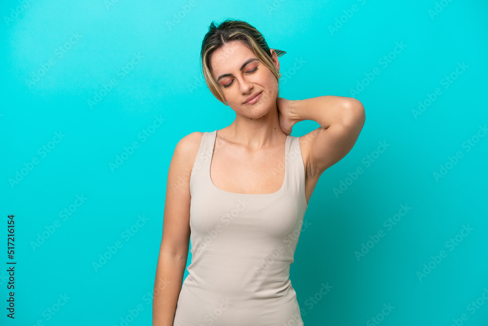 Young caucasian woman isolated on blue background with neckache Young caucasian woman isolated on blue background with neckache