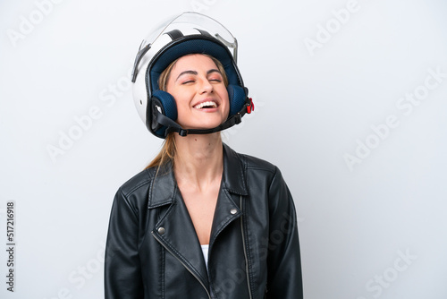 Young caucasian woman with a motorcycle helmet isolated on white background laughing © luismolinero