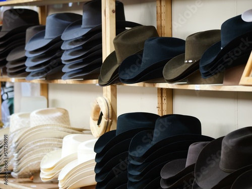 Billede på lærred Closeup of stack of cowboy hats on shelf in a store