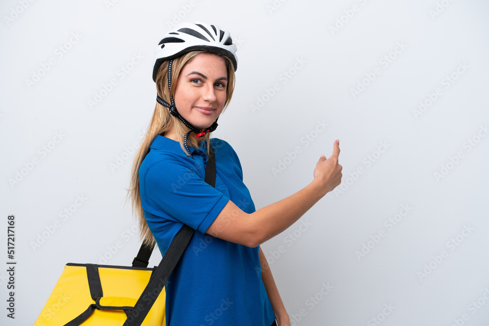 Young caucasian woman with thermal backpack isolated on white background pointing back Young caucasian woman with thermal backpack isolated on white background pointing back
