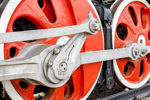 wheelset of an old red steam locomotive. old steam locomotive