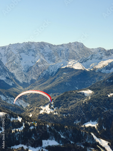 Paraglider flying over the valley in Garmisch in German Alps