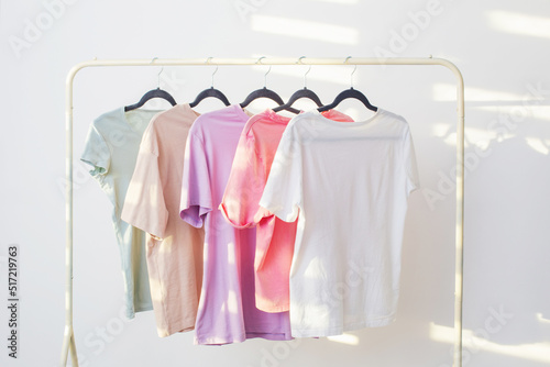 women's t-shirts on hanger on white background