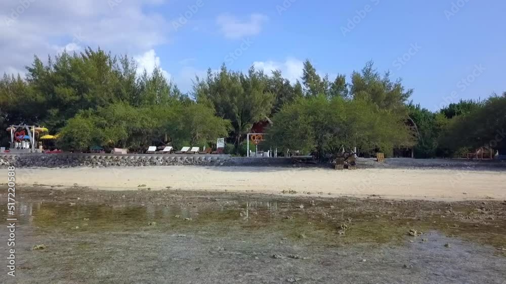 Lovers seeking shade under a bush big heart.Perfect aerial view flight fly forward drone footageof Gili Trawangan beach sunny summer day Lombok Indonesia 2017 Lovers seeking shade under a bush big heart.Perfect aerial view flight fly forward drone footageof Gili Trawangan beach sunny summer day Lombok Indonesia 2017