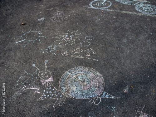 Сhildren's drawings on the pavement with crayons of different colors.