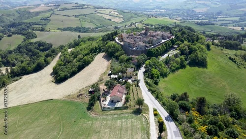 Drone footage of the small village surrounded by green vegetation. Montefabbri, Italy. photo