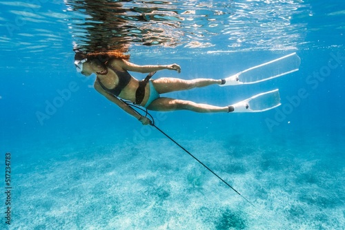 Obraz na plátně Female spearfishing under the water in the Bahamas