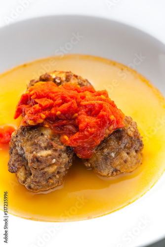 broth with meatballs and tomato sauce photo