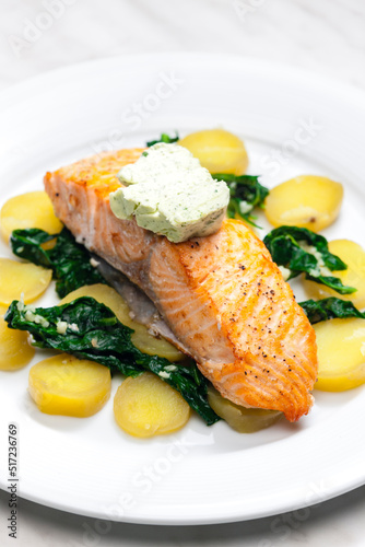 baked salmon with spinach leaves and potatoes