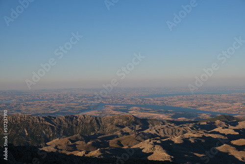 Perfect panoramic view at sunrise from Nemrut mountain. Blue sky and hills background.