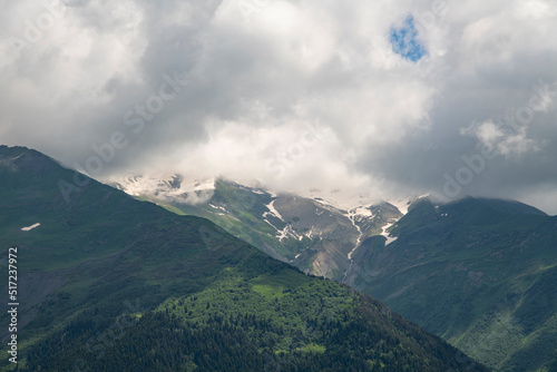 Clouds over the mountains and green hills. © Inga Av