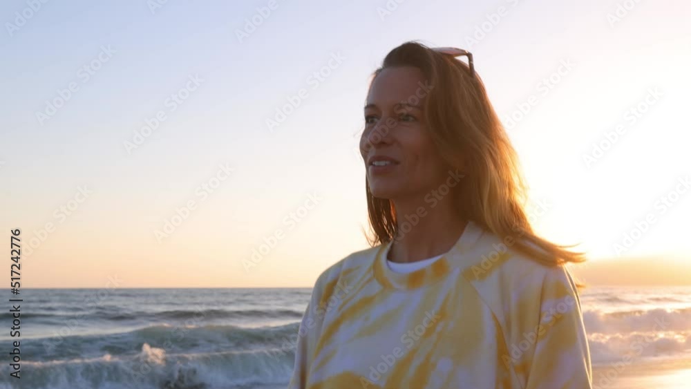 Woman walking along the beach at sunset. Santa Monica California. Woman walking along the beach at sunset. Santa Monica California.