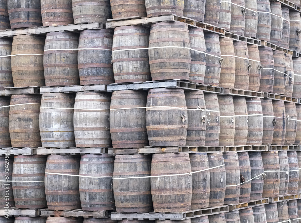 Whisky casks stacked at distillery for storage Whisky casks stacked at distillery for storage