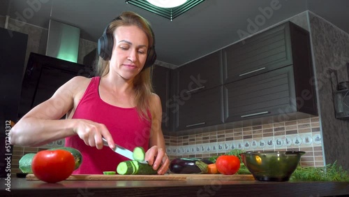 girl cutting salad in the kitchen