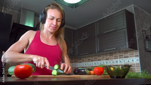 girl cutting salad in the kitchen