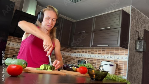 girl cutting salad in the kitchen