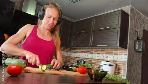 girl cutting salad in the kitchen