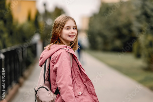 Schoolgirl walking at street © tan4ikk