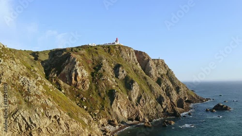 Drone flying over high hill rocks top view Atlantic ocean shores around cape Cabo da Roca in Sintra Portugal lighthouse westernmost point of Eurasian continent beautiful archipelagos natural scenery photo