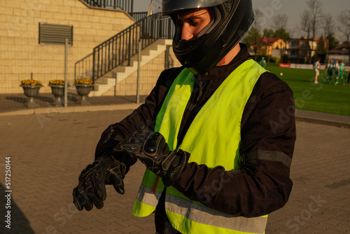 Заголовок	
Motorcyclist in a driving lesson. Lessons in auto and motorcycle school. A student in a special uniform drives a motorcycle. Summer training on a moped. Student and teacher.	
