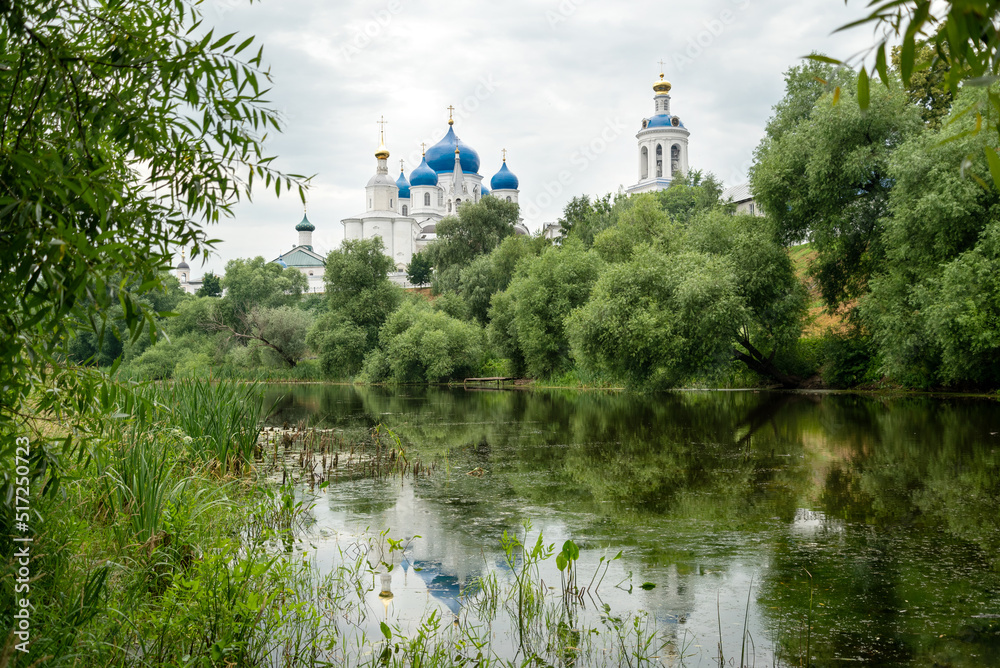Domes of Holy bogolyubovsky monastery reflects in lake waters