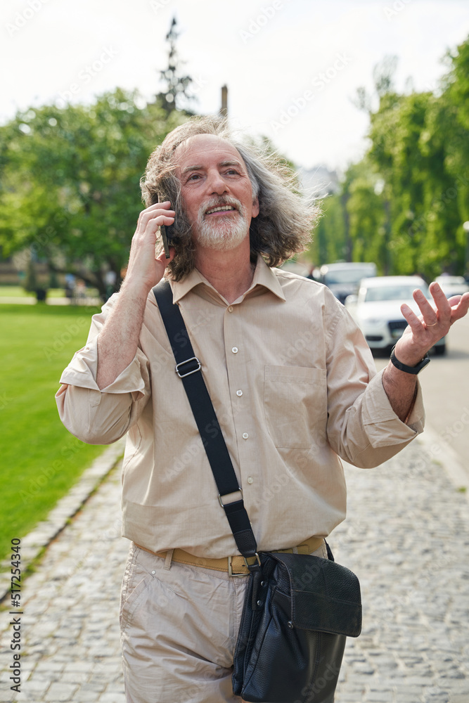 Kind grey-haired man walking in the street Kind grey-haired man walking in the street