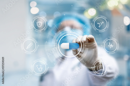 Photos Doctor shows medicine on the background of a computer.
