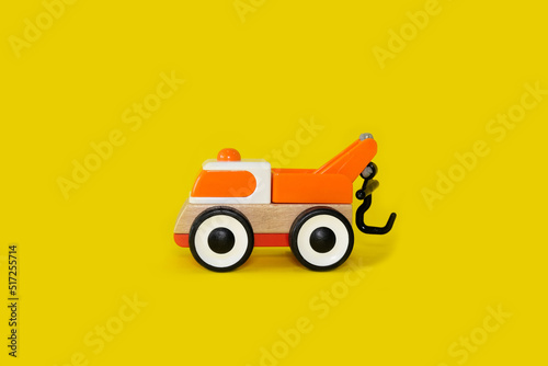 Children's toy car on a bright yellow background