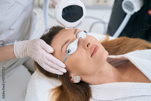 Patient in cosmetology center undergoes a forehead skin rejuvenation procedure