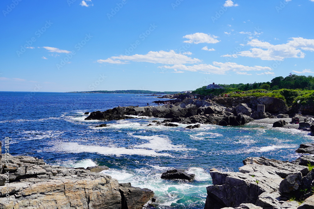 Atlantic ocean waves and rock beach along coastline in Portland, Maine, USA