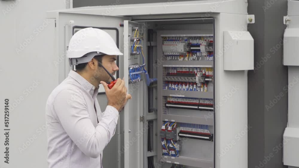 An engineer man or worker, people working in electrical room. Power energy motor machinery cabinets with panel in control or server room, operator station network in industry factory. Switchgear An engineer man or worker, people working in electrical room. Power energy motor machinery cabinets with panel in control or server room, operator station network in industry factory. Switchgear