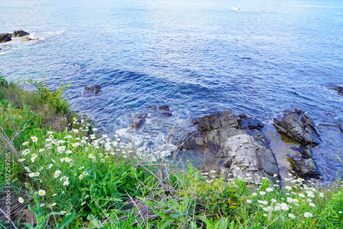 Atlantic ocean waves and rock beach along coastline in Portland, Maine, USA photo