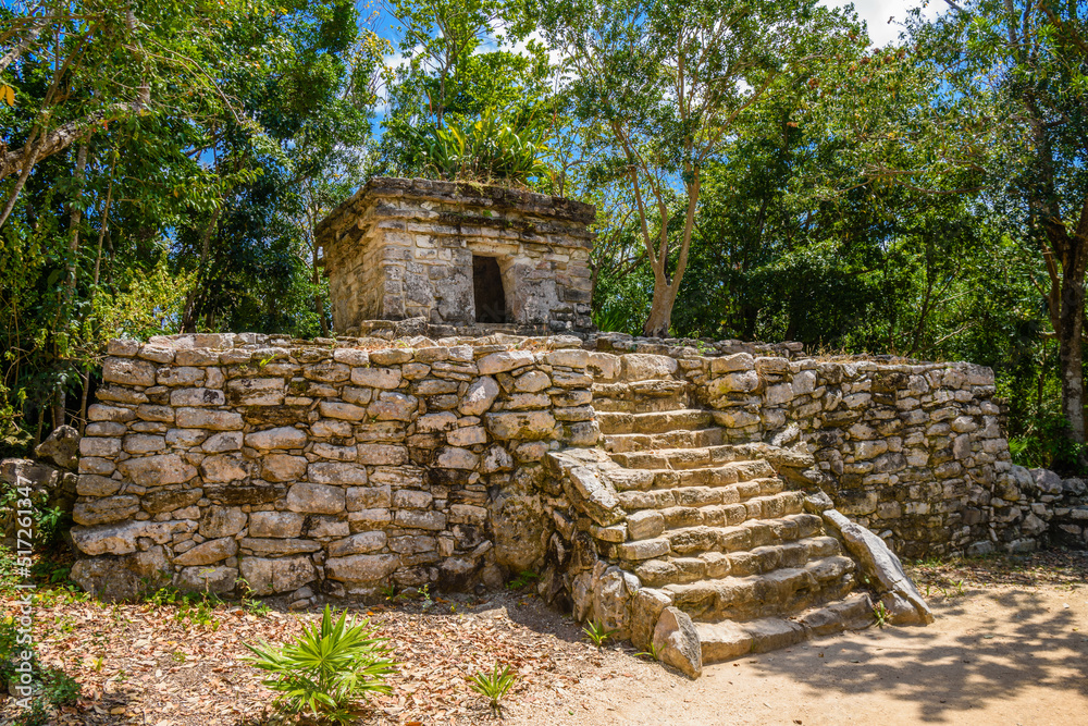 Mayan ruins in shadow of trees in jungle tropical forest Playa del Carmen, Riviera Maya, Yu atan, Mexico