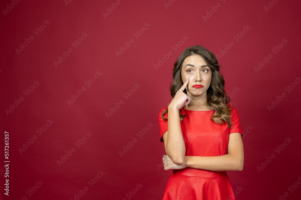 Woman is about to cry on a red background Woman is about to cry on a red background