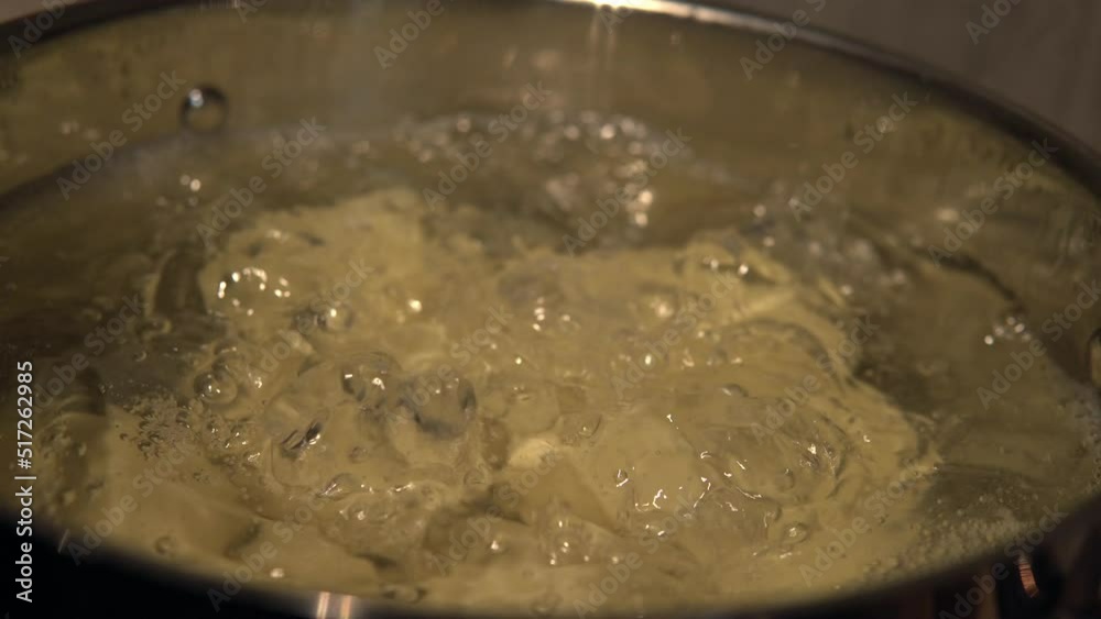 Revealing a pot full of potatoes boiling in water. Homemade food concept. Handheld. Revealing a pot full of potatoes boiling in water. Homemade food concept. Handheld.