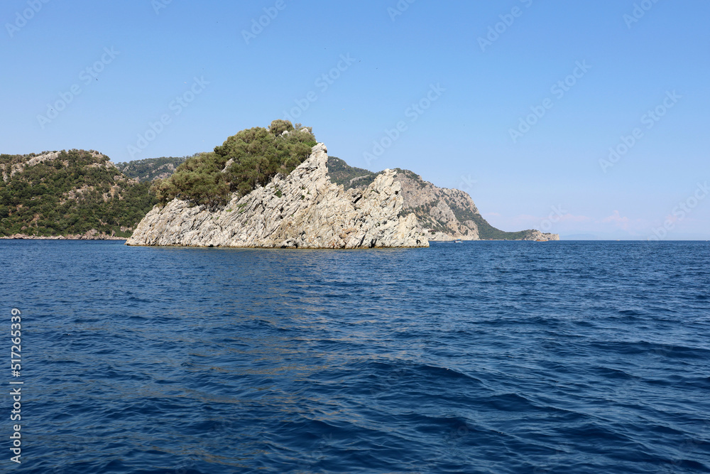 View to blue sea and rock islands on horizon. Deep water, background for traveling and vacation