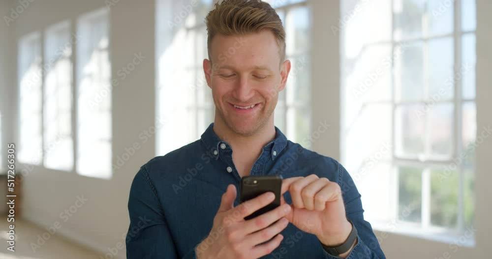 Young man laughing at a funny joke and using a phone to chat with friends online. Happy and cheerful male browsing the internet and using social media. One guy scrolling on the web and reading a text
