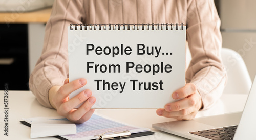 People Buy From People They Trust. Businessman holding a card with a message text written
