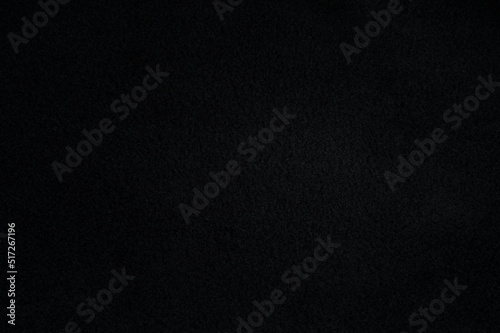 Black fleece texture and background. Close-up dark fleece fabric surface