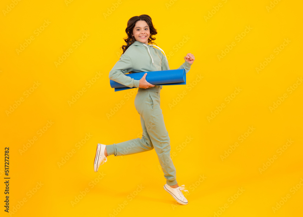 Run and jump. Teen girl 12, 13, 14 years old in sport suit. Fashion child in sportswear sportive clothing. Sportive fashionable outfit. Studio shot on yellow background. Run and jump. Teen girl 12, 13, 14 years old in sport suit. Fashion child in sportswear sportive clothing. Sportive fashionable outfit. Studio shot on yellow background.