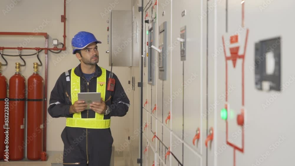 An engineer man or worker, people working in electrical room. Power energy motor machinery cabinets with panel in control or server room, operator station network in industry factory. Switchgear An engineer man or worker, people working in electrical room. Power energy motor machinery cabinets with panel in control or server room, operator station network in industry factory. Switchgear