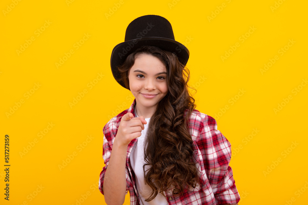 Teenager girl in magician hat, cylinder hat isolated on yellow background. Headwear. Clothes accessories. Fashion headwear for gentlemen in vintage style, old classic cylinder. Teenager girl in magician hat, cylinder hat isolated on yellow background. Headwear. Clothes accessories. Fashion headwear for gentlemen in vintage style, old classic cylinder.