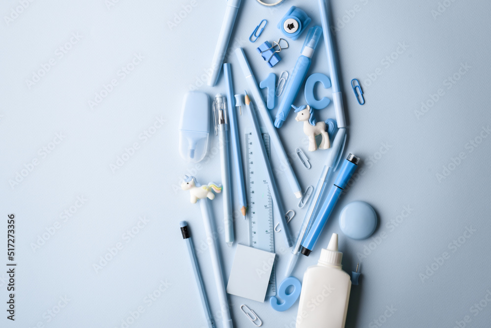 Fototapeta premium Background with various light blue stationery lying in the center. Back to school.